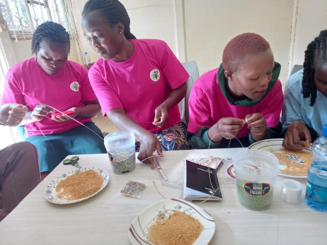 Caregivers learning beadwork skills