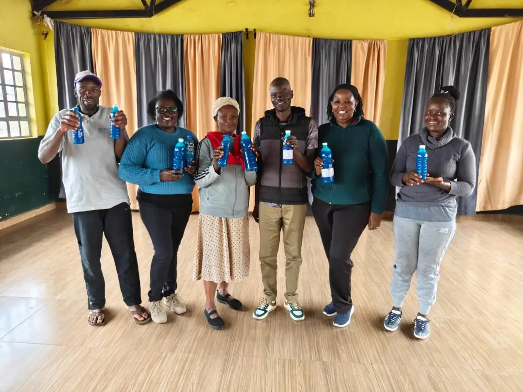 Caregivers holding bottles of their first branded liquid soap